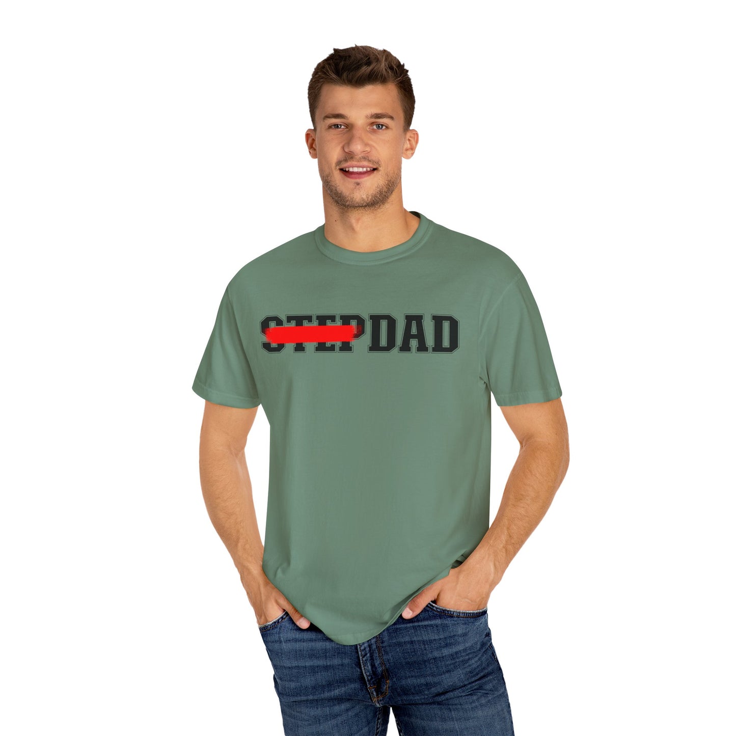 A green t-shirt with black 'STEP DAD' text across the chest, the word 'STEP' is crossed out with a red line so only 'DAD' is easily readable.