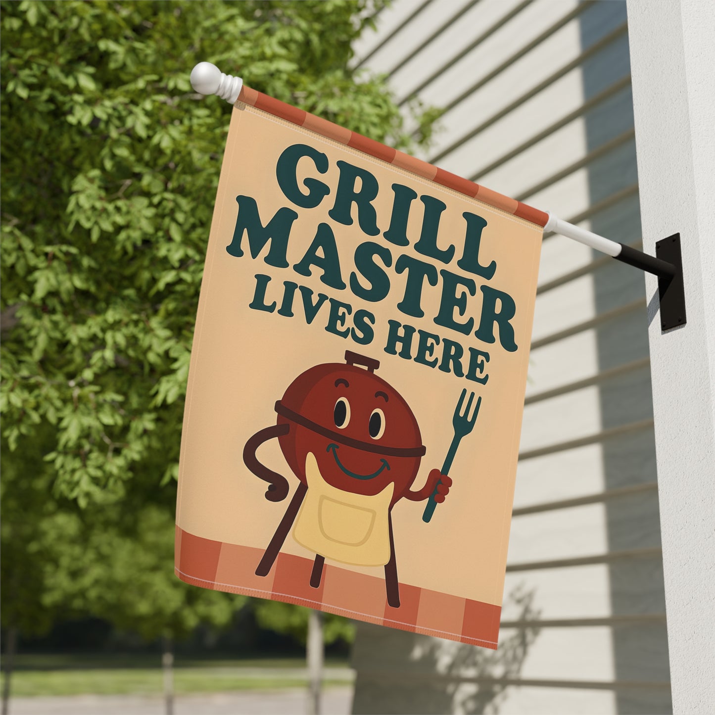 Garden flag with 'Grill Master Lives Here' text and cartoon style image of a smiling grill holding a grill fork.