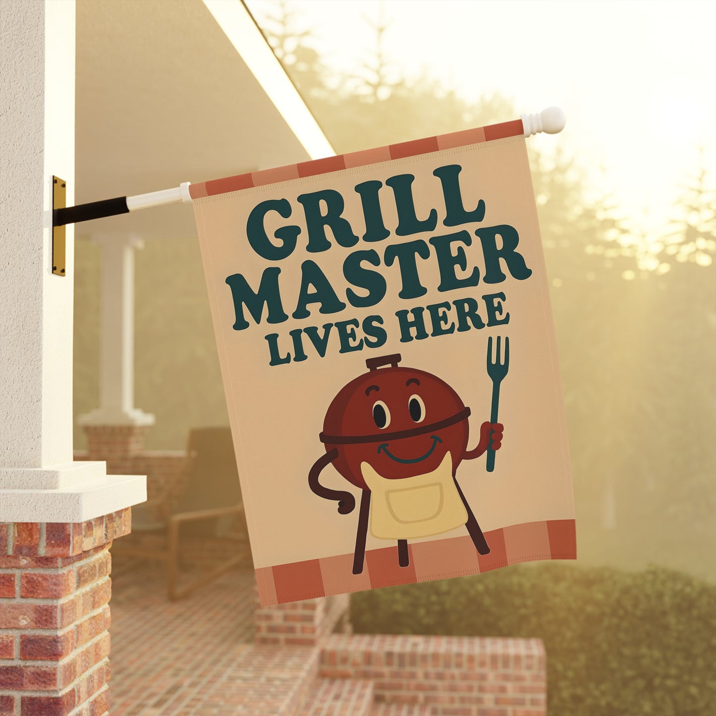 Garden flag with 'Grill Master Lives Here' text and cartoon style image of a smiling grill holding a grill fork.