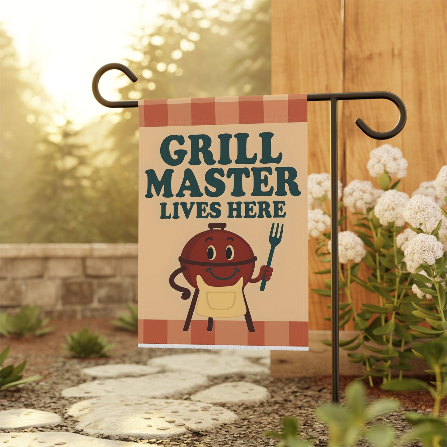 Garden flag with 'Grill Master Lives Here' text and cartoon style image of a smiling grill holding a grill fork.