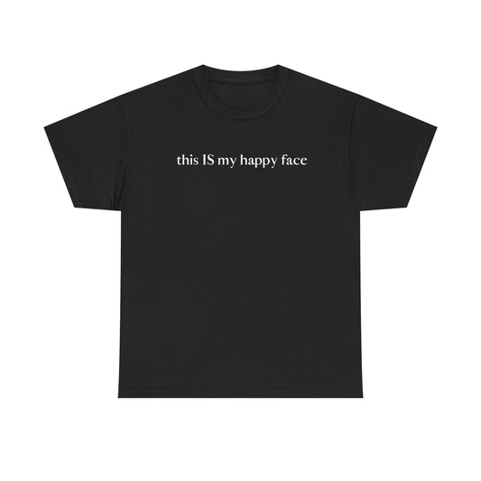 A black unisex cotton t-shirt with the text 'this IS my happy face' printed in white across the chest. All characters are lower case except the word 'IS' which are in capital letters.