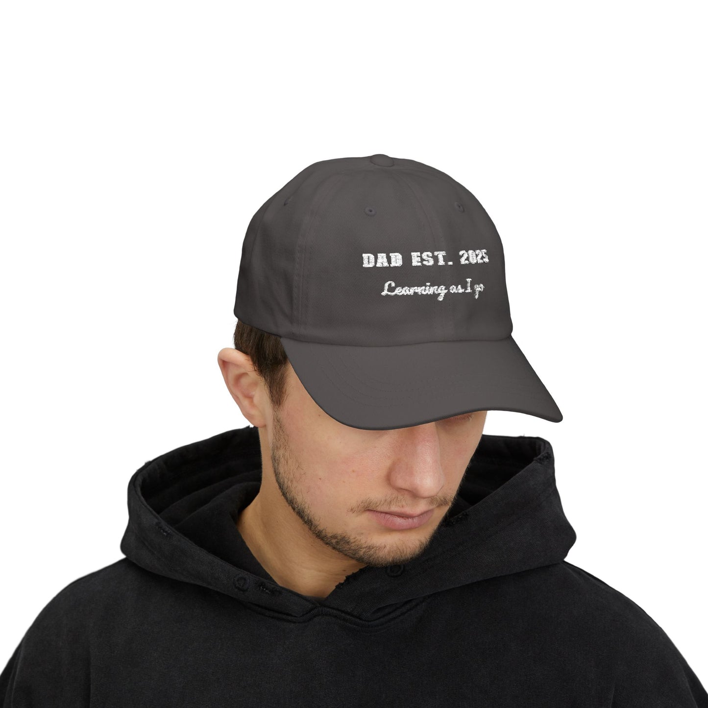 Customizable year, Dark gray cap with text 'DAD EST. 2025 Learning as I go' in a white text