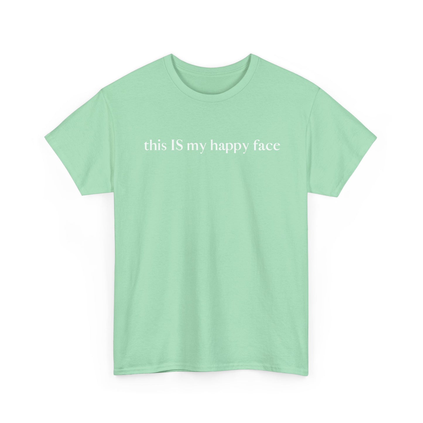 A light green unisex cotton t-shirt with the text 'this IS my happy face' printed in white across the chest. All characters are lower case except the word 'IS' which are in capital letters.